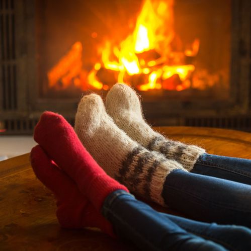 a couple in front of a fire